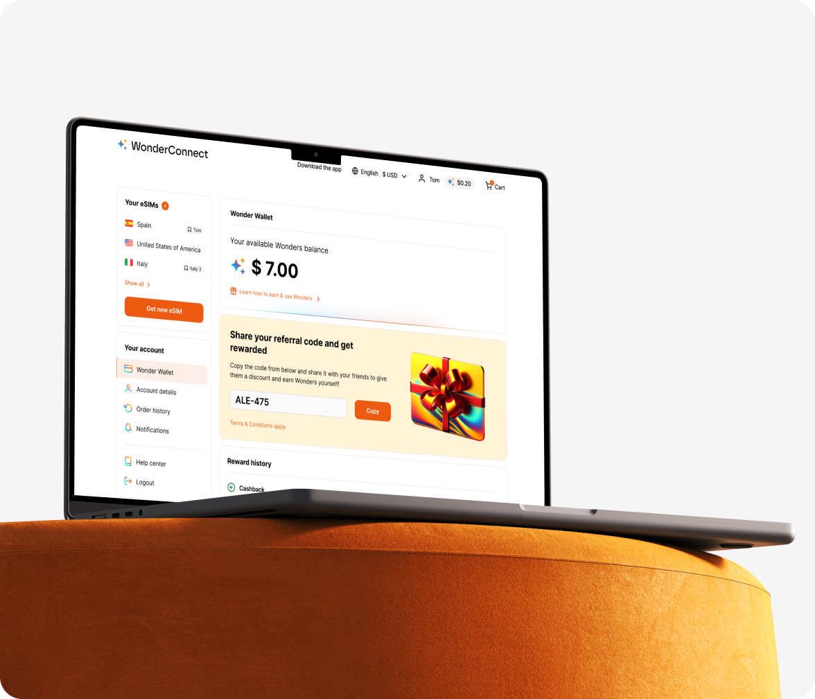 A laptop displaying the WonderConnect wallet page with loyalty points balance, and exemplary account details.